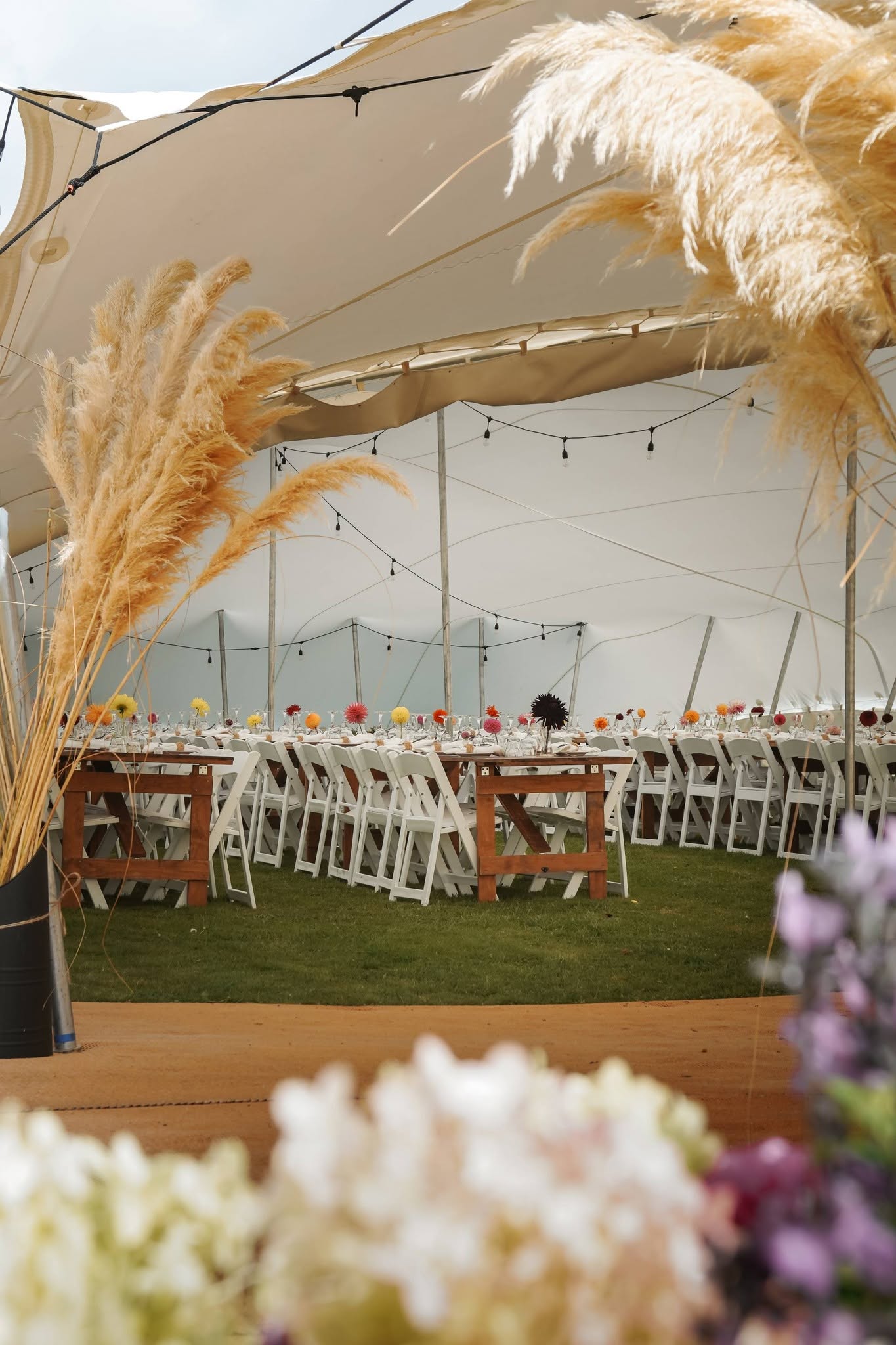 Elegant event setup at Brunel Peaks with tent, tables, and flowers